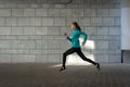 Young adult athlete woman jogging outdoor in city Royalty Free Stock Photo