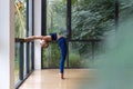 Young adult athletic female practicing yoga in gym club Royalty Free Stock Photo