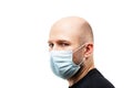 Young adult bald head man wearing respiratory protective medical mask Royalty Free Stock Photo