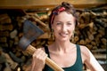 Young adult beautiful happy  attractive caucasian brunette woman portrait have fun enjoy holding old rusty axe chopping Royalty Free Stock Photo