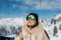 Young adult beautiful happy attractive caucasian smiling woman enjoy ascent sitting inside ski lift gondola cable car against