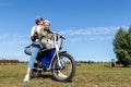 Young adult beautiful mother and daughter enjoy having fun riding electric scooter bike or rural countryside dirt road Royalty Free Stock Photo