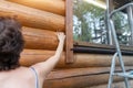 Young adult beautiful slim sporty caucasian woman stand near metal ladder and washing wooden house building wall Royalty Free Stock Photo