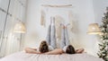 Young adult boyfriend and girlfriend spending morning in bedroom Royalty Free Stock Photo