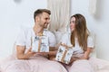 Young adult boyfriend and girlfriend spending morning in bedroom Royalty Free Stock Photo