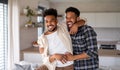 Young adult brothers in kitchen indoors at home, having fun. Royalty Free Stock Photo