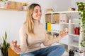 Young adult business woman doing yoga on table at home office Royalty Free Stock Photo