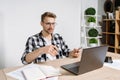 Young adult businessperson making video call in office