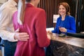 Young adult caucasian business couple checking in at reception in hotel Royalty Free Stock Photo