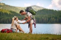 young adult couple taking a break of hiking in nature, looking at the map Royalty Free Stock Photo