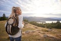 A young adult Caucasian woman standing alone on the hill during hiking, admiring view, back view Royalty Free Stock Photo