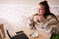 Young adult chubby woman holding a coffee while smiling