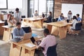 Young adult colleagues working in busy office, elevated view Royalty Free Stock Photo