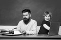 Young adult concept. Father and son typing on old typewriter and laptop. Old and young people. Technology progress. Royalty Free Stock Photo