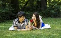 Young Adult Couple Enjoy Looking at Single Red Rose Royalty Free Stock Photo