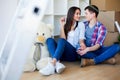 Young Adult Couple Inside Room with Boxes Holding New House Keys Royalty Free Stock Photo