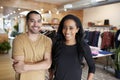 Young adult couple smiling to camera in a clothes shop Royalty Free Stock Photo