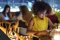 Young adult on a dinner date using a smartphone addiction concep