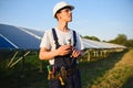 Young adult doing professional training on solar panels plant