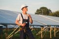 Young adult doing professional training on solar panels plant