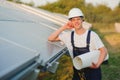 Young adult doing professional training on solar panels plant