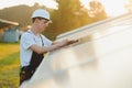 Young adult doing professional training on solar panels plant