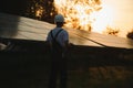 Young adult doing professional training on solar panels plant