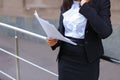 Young adult female asian girl student holds in hands documents o