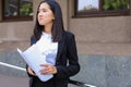 Young adult female asian girl student holds in hands documents o