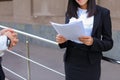 Young adult female asian girl student holds in hands documents o