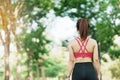 Young adult female in pink sportswear stretching muscle in the park outdoor, sport woman warm up ready for running and jogging in Royalty Free Stock Photo