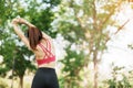 Young adult female in pink sportswear stretching muscle in the park outdoor, sport woman warm up ready for running and jogging in Royalty Free Stock Photo