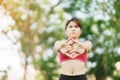 Young adult female in pink sportswear stretching muscle in the park outdoor, sport woman warm up ready for running and jogging in Royalty Free Stock Photo