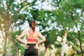 Young adult female in pink sportswear stretching muscle in the park outdoor, sport woman warm up ready for running and jogging in Royalty Free Stock Photo