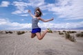 Young adult female woman jumps in the Mesquite Sand Dunes in Death Valley National Park in California Royalty Free Stock Photo