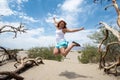 Young adult female woman jumps in the Mesquite Sand Dunes in Death Valley National Park in California Royalty Free Stock Photo