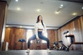 Young adult fitness woman doing swing exercise with a kettlebell as a part of a fitness workout Royalty Free Stock Photo