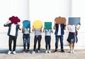 Young adult friends holding up copyspace placard thought bubbles