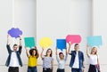 Young adult friends holding up copyspace placard thought bubbles