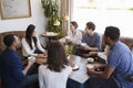 Young adult friends talking around a table at a coffee shop