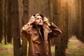 A young adult handsome man, with a mysterious look, in a dark wild forest. Royalty Free Stock Photo