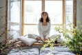 African American ethnic woman wearing white clothes sitting in yoga pose Royalty Free Stock Photo