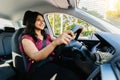 Young adult happy indian woman driving a car in the city. Royalty Free Stock Photo