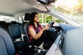 Young adult happy indian woman driving a car in the city. Royalty Free Stock Photo