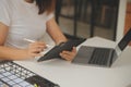 Young adult happy smiling Hispanic Asian student wearing headphones talking on online chat meeting using laptop in university Royalty Free Stock Photo