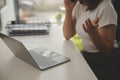 Young adult happy smiling Hispanic Asian student wearing headphones talking on online chat meeting using laptop in university Royalty Free Stock Photo