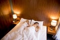 Young adult heterosexual couple on bed in bedroom Royalty Free Stock Photo