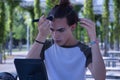 Young adult Hispanic transsexual girl doing her makeup in front of a hand mirror. Concept of transsexuality, inclusion and Royalty Free Stock Photo