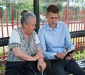 Young man preaching to an old woman Royalty Free Stock Photo