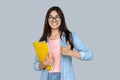 Young adult indian student girl with copybooks showing thumb up